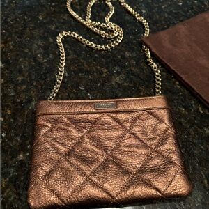 Kate Spade purse, 6 3/4 inch wide and 4 3/4 inch long. Shiny gold/brown